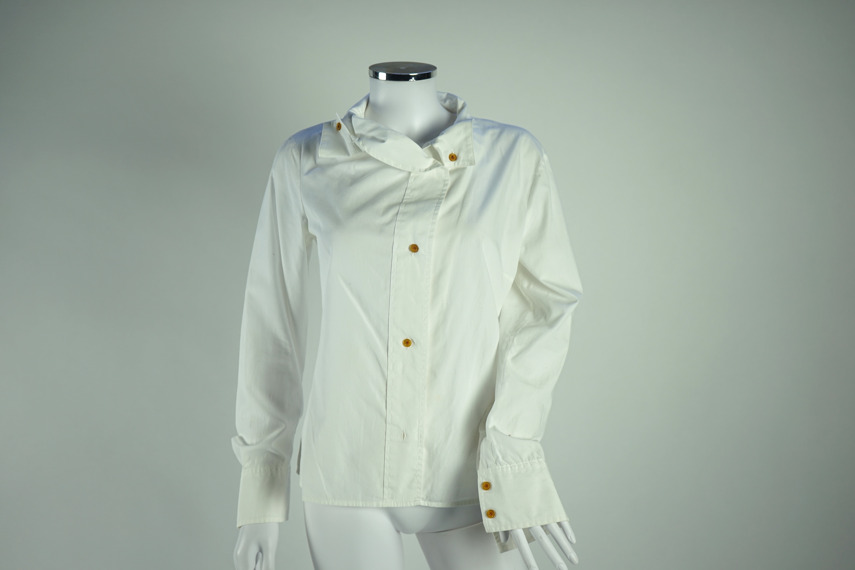 A Diane von Furstenberg cream silk lady's blouse with rope detail, a Dusk for Frank Usher cream silk waistcoat and a white cotton shirt, size 10